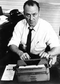 Bernard Kilgore looking up from a typewriter